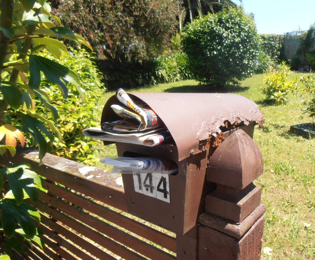 Letterbox with newspapers and catalogues